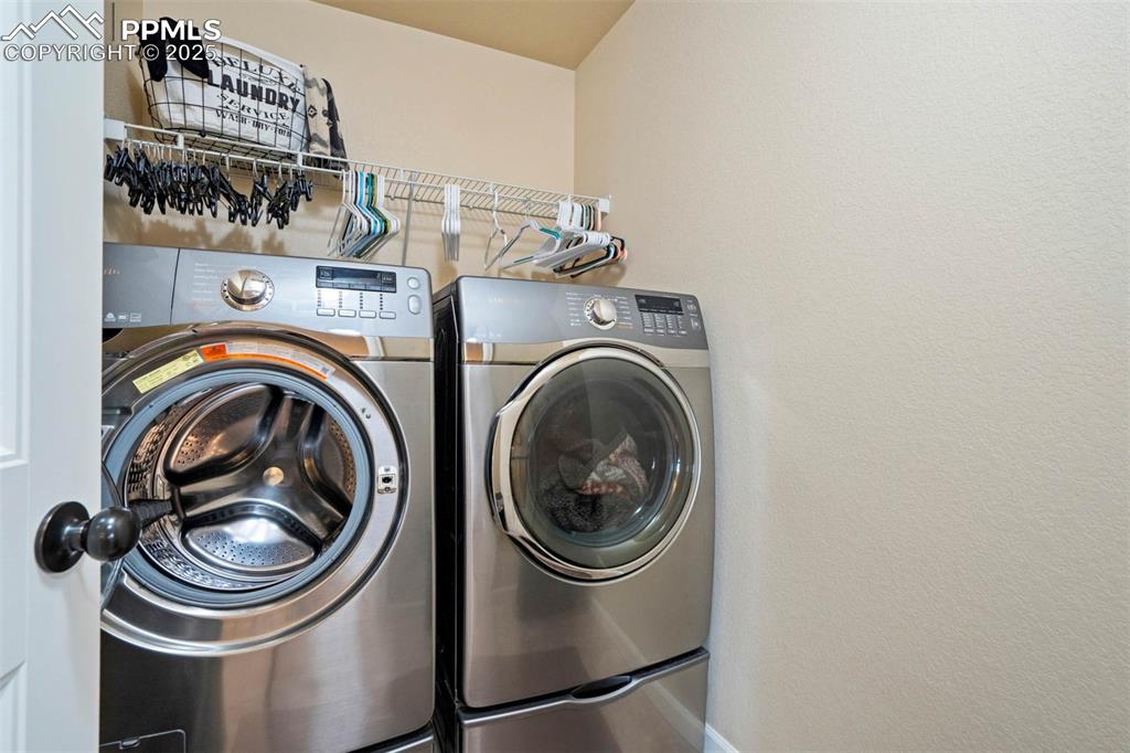 Image 32 of 49: Laundry room with washing machine and clothes dryer