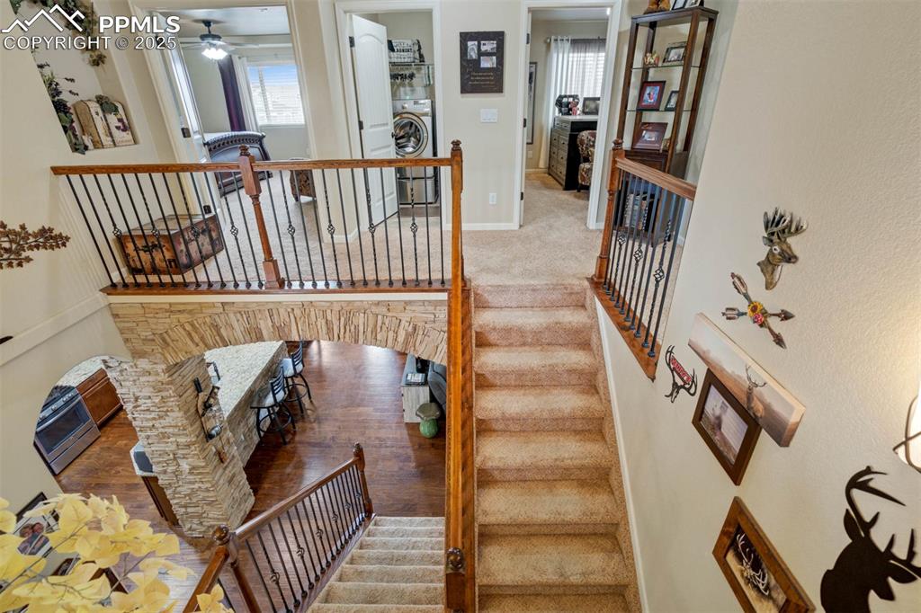 Image 35 of 49: Staircase with washer / clothes dryer and ceiling fan
