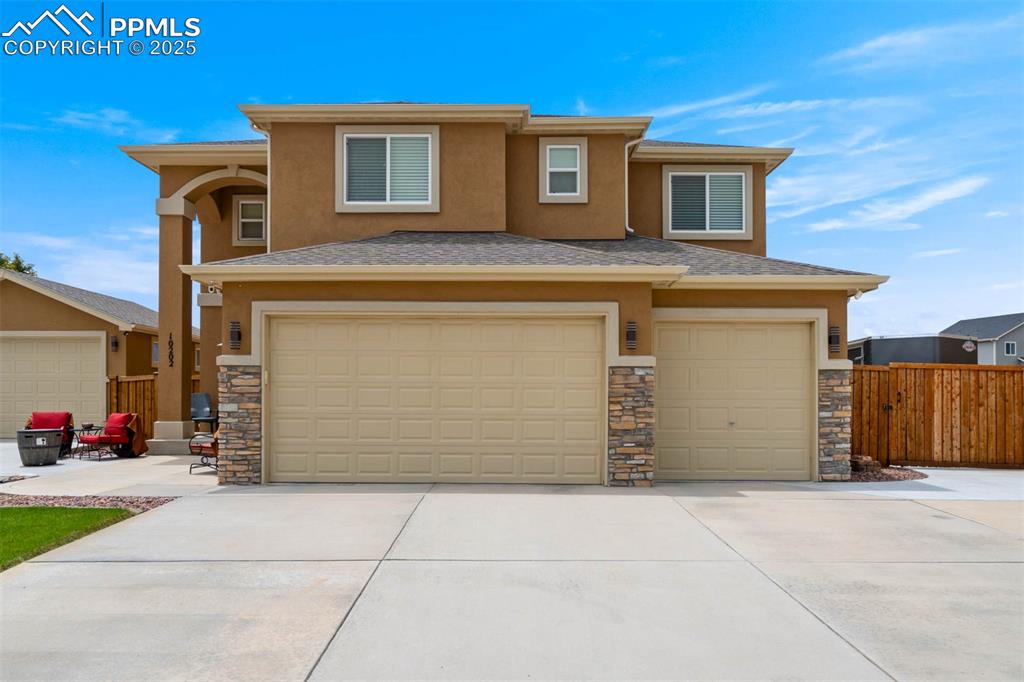 Image 4 of 49: Prairie-style home featuring an attached garage, stucco siding, concrete dr