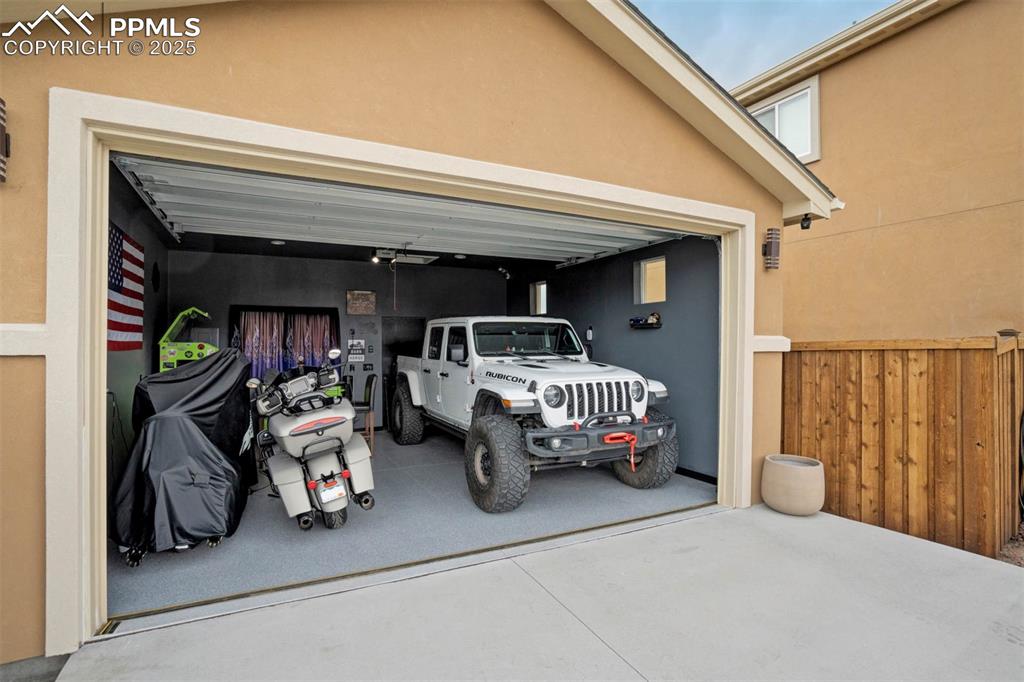 Image 44 of 49: Garage featuring concrete driveway