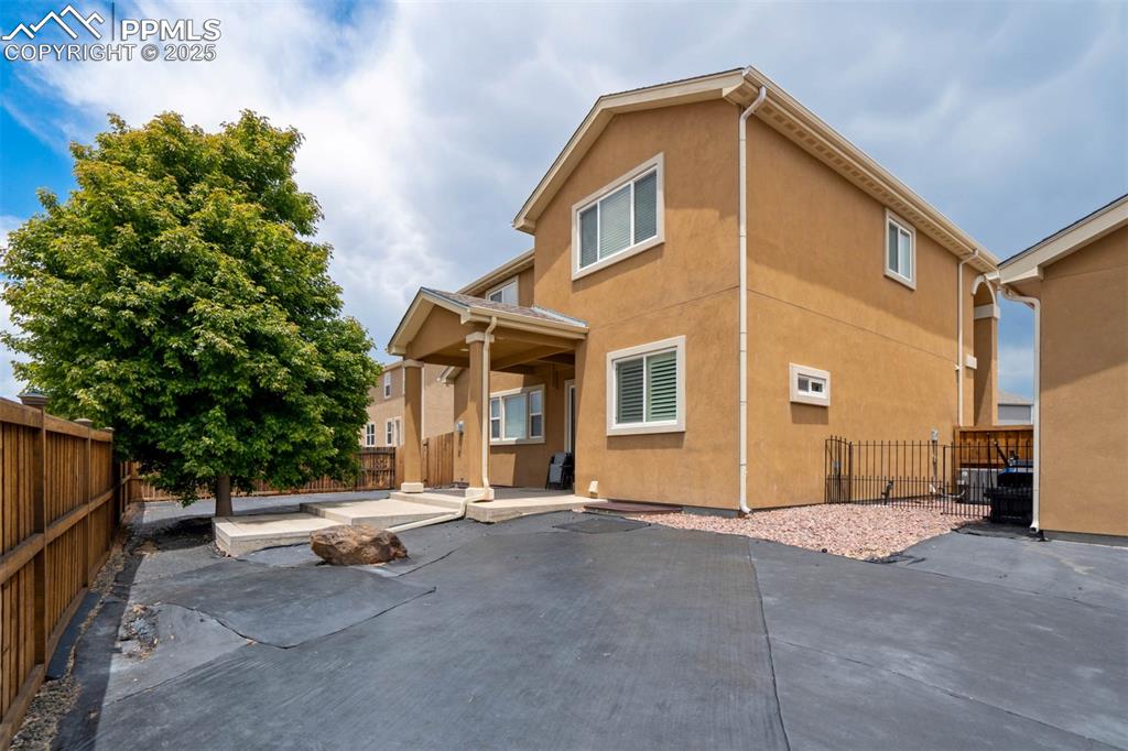 Image 45 of 49: Back of house featuring stucco siding, a patio area, and a fenced backyard
