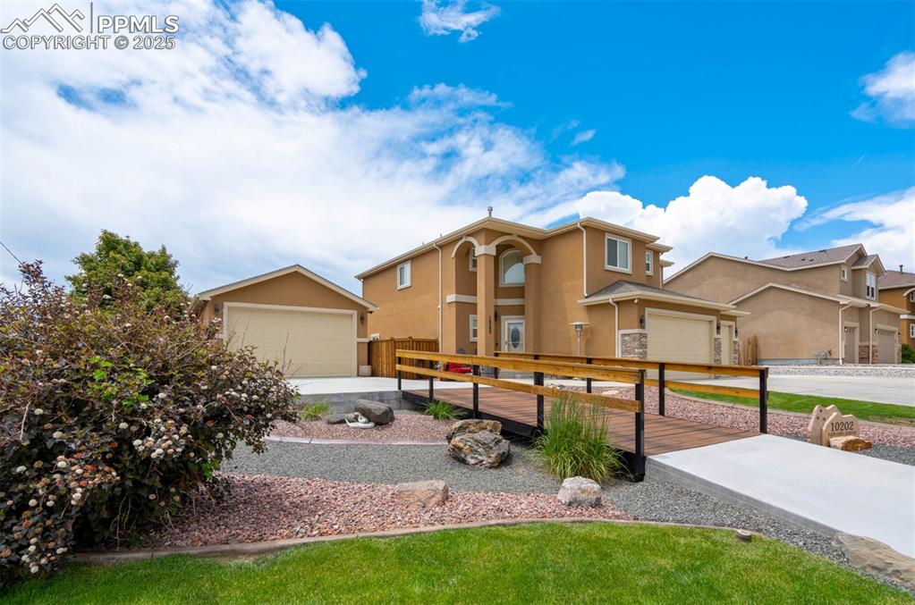 Image 6 of 49: View of front of home featuring stucco siding