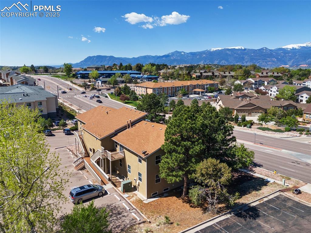 Image 10 of 50: Aerial view of residential area featuring a mountain backdrop