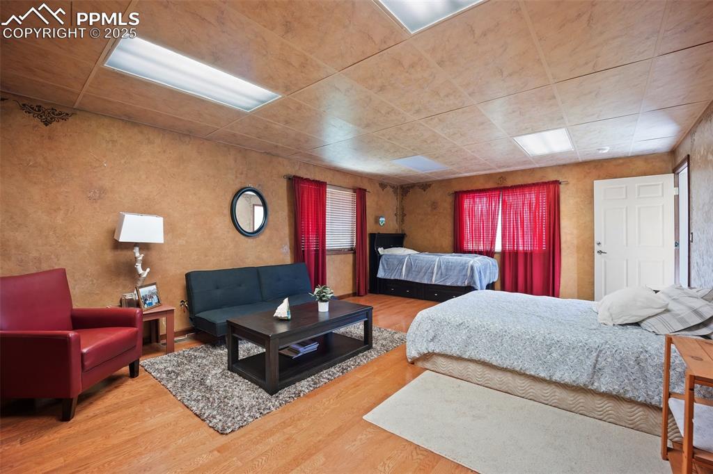 Image 11 of 50: Bedroom featuring wood finished floors - 5785 Building 
