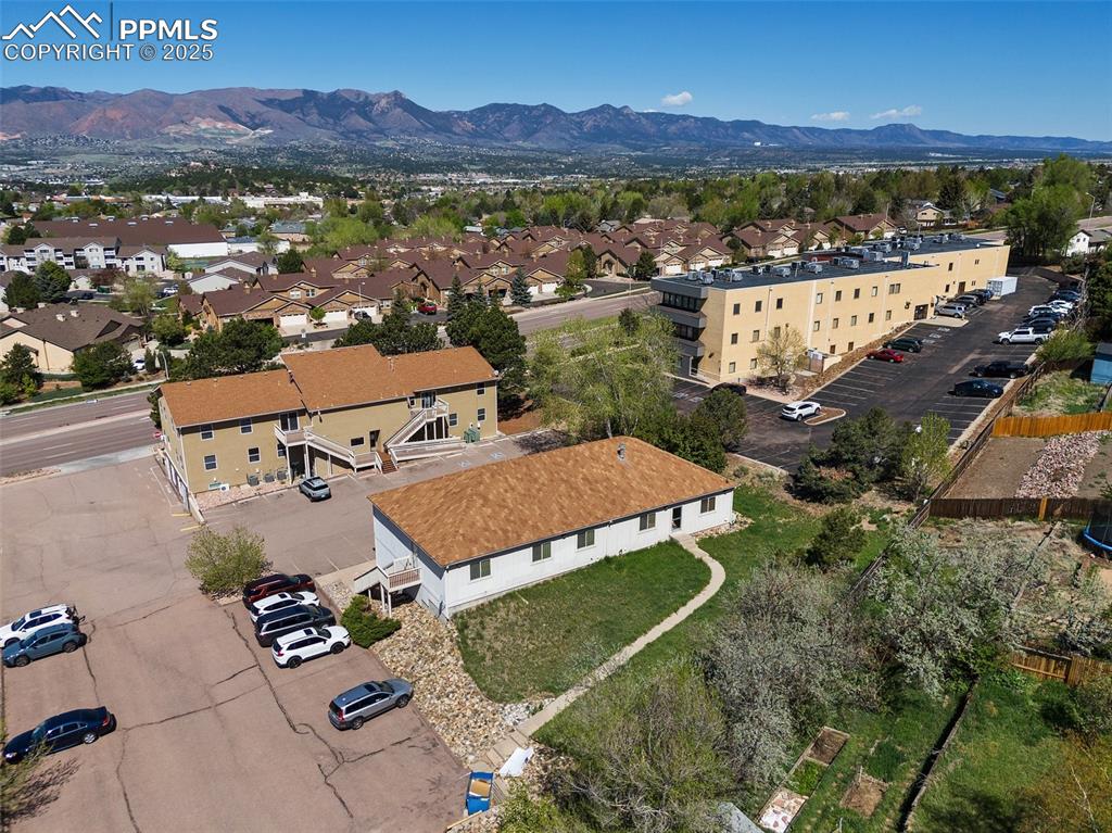 Image 3 of 50: Aerial perspective of suburban area featuring mountains