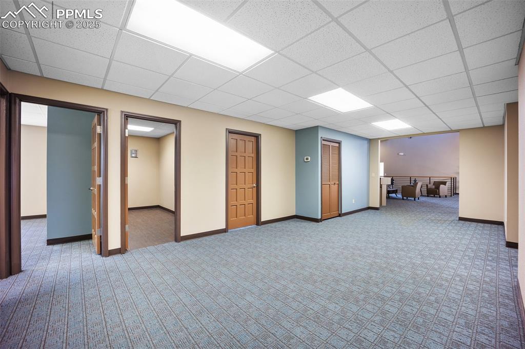 Image 30 of 50: Below grade area featuring carpet floors, a drop ceiling, and baseboards-57