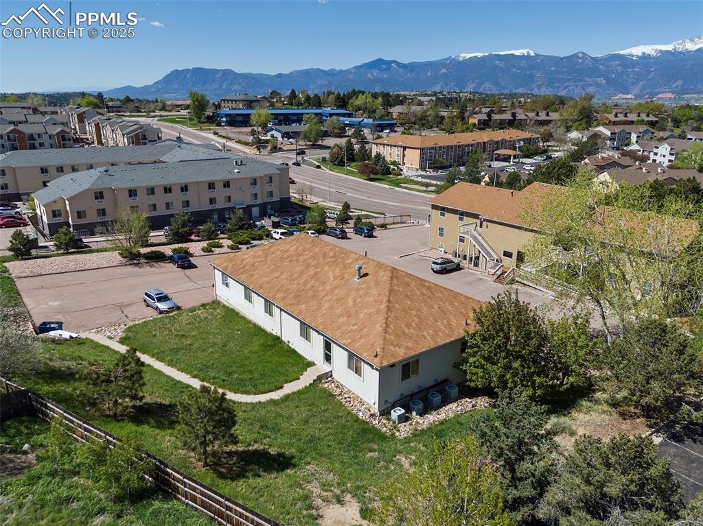 Image 4 of 50: Aerial view of residential area with a mountain backdrop