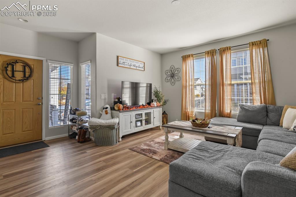 Image 5 of 27: Living area with plenty of natural light and wood finished floors