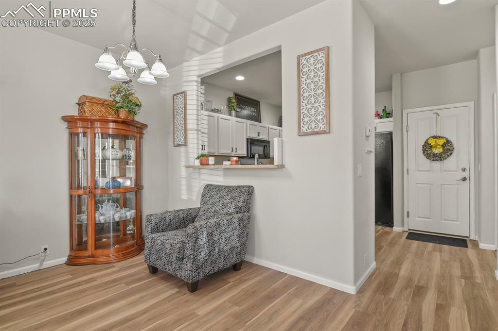 Image 7 of 27: Sitting room featuring light wood-type flooring, recessed lighting, and a c