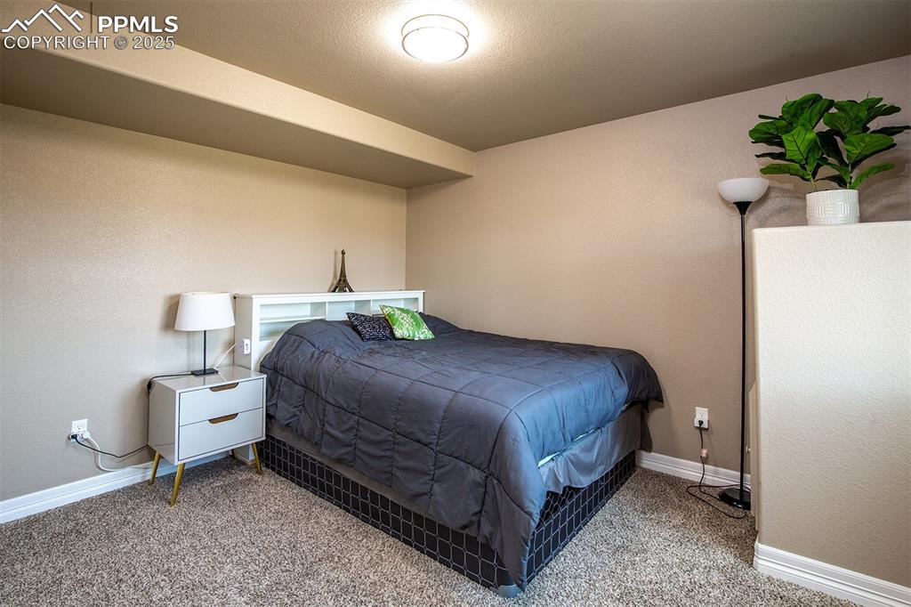 Image 20 of 40: Bedroom with carpet floors and baseboards