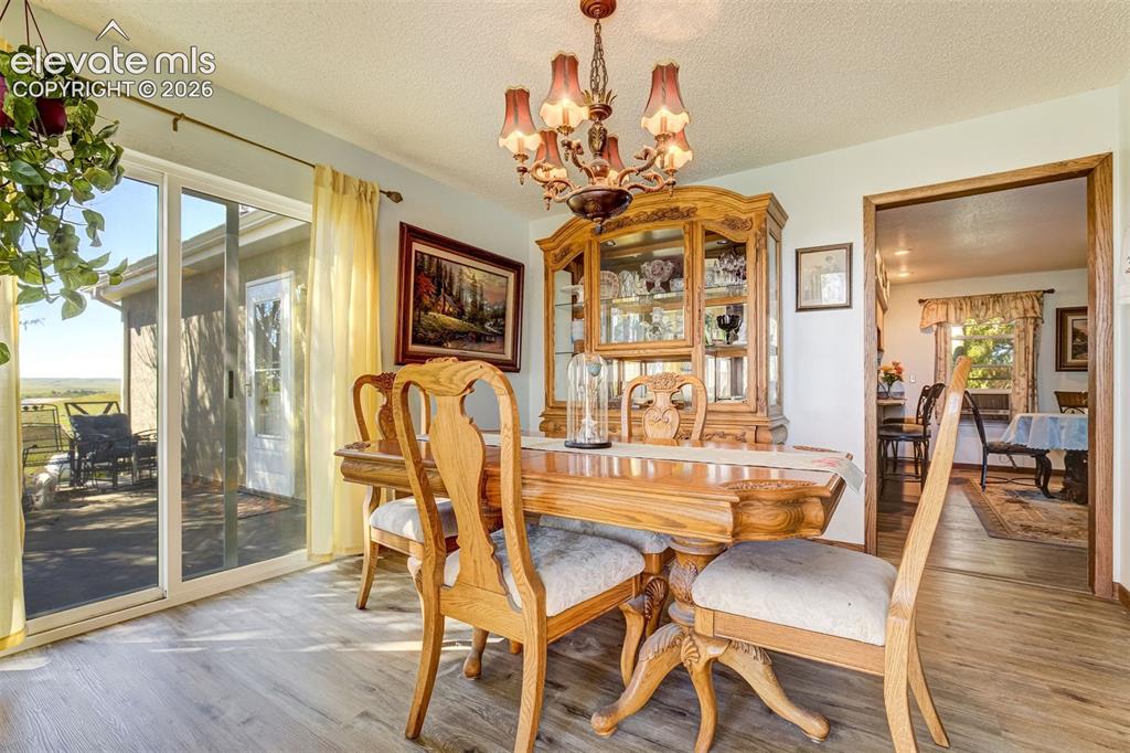 Image 7 of 50: Brand new LPV flooring. Beautiful dining room.  Walk out to the deck.