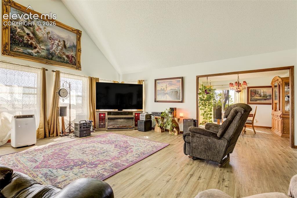 Image 9 of 50: Brand new LPV flooring. Large living room with vaulted ceilings and brand n