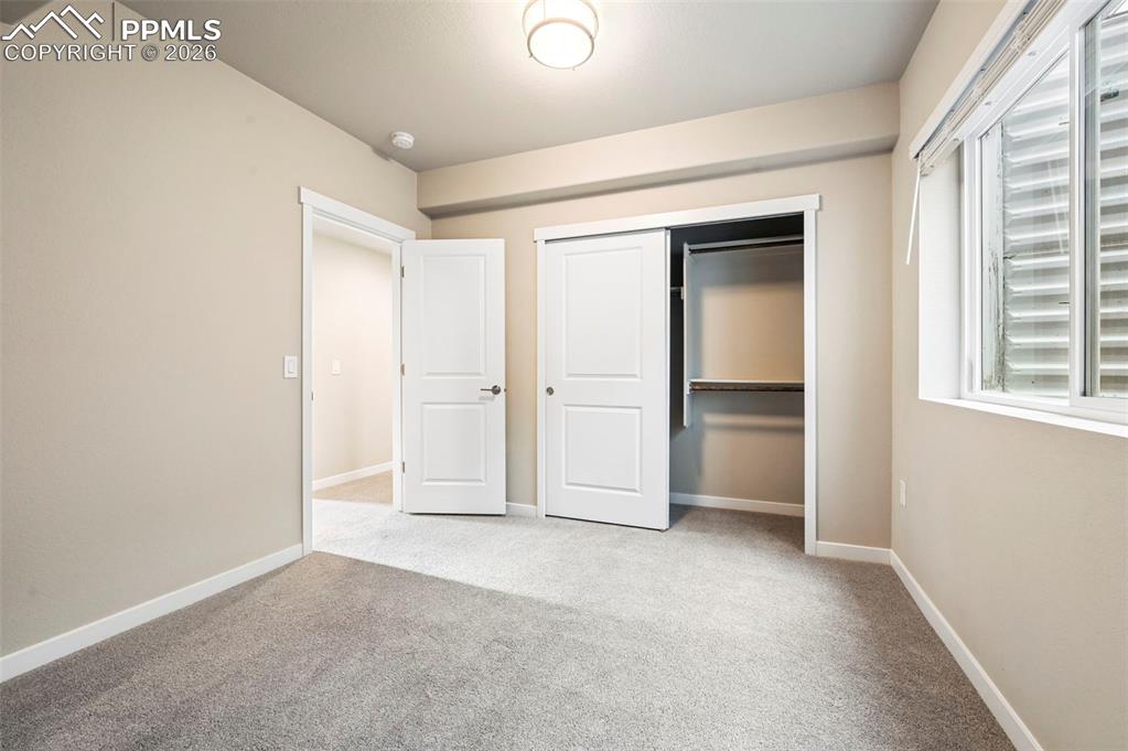 Image 47 of 50: virtually staged 3rd bedroom in the basement