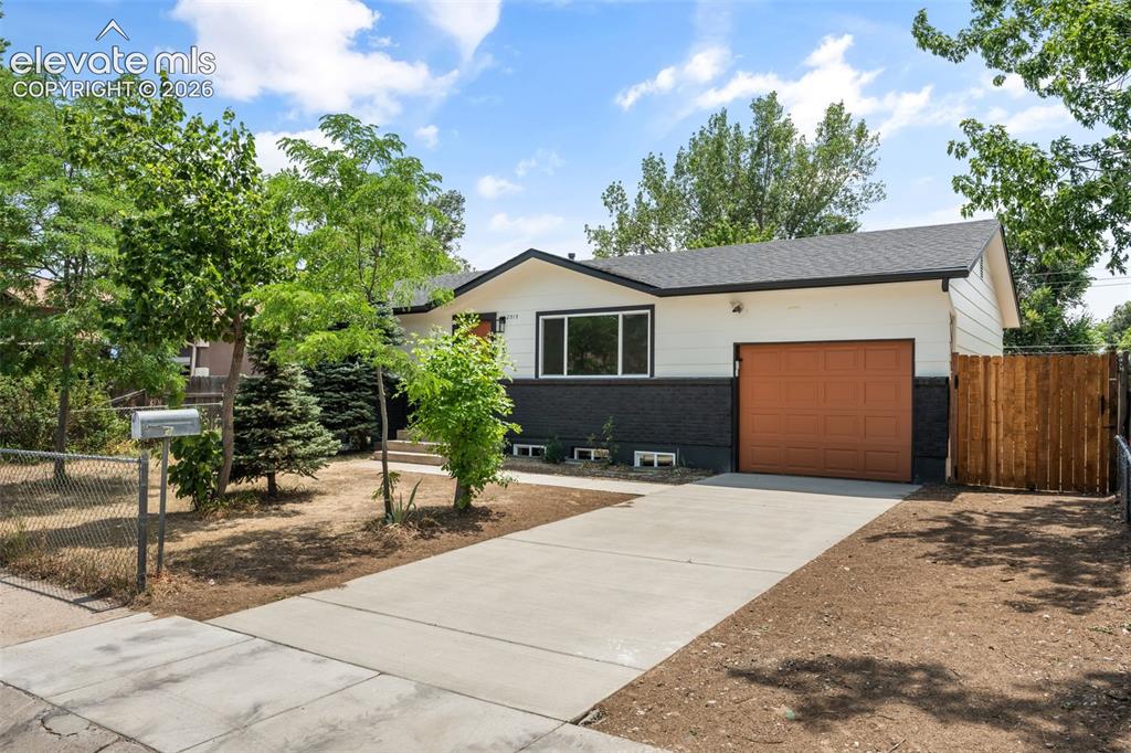Image 1 of 35: Exterior featuring white siding with a dark lower accent, a brown garage do