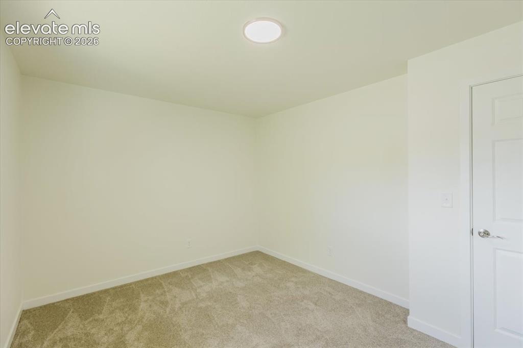 Image 11 of 27: Neutral tone walls with white baseboards and trim