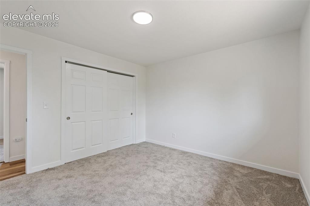 Image 17 of 35: Plush grey carpeting complements a neutral wall palette