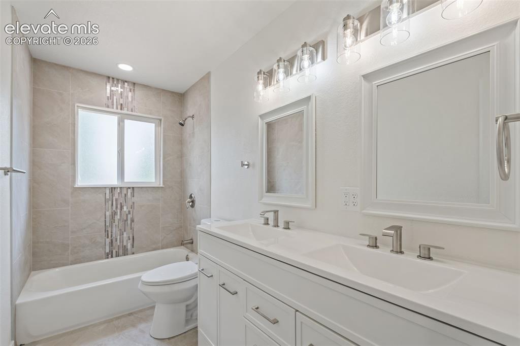 Image 19 of 35: Dual vanity with integrated sinks and brushed nickel hardware
