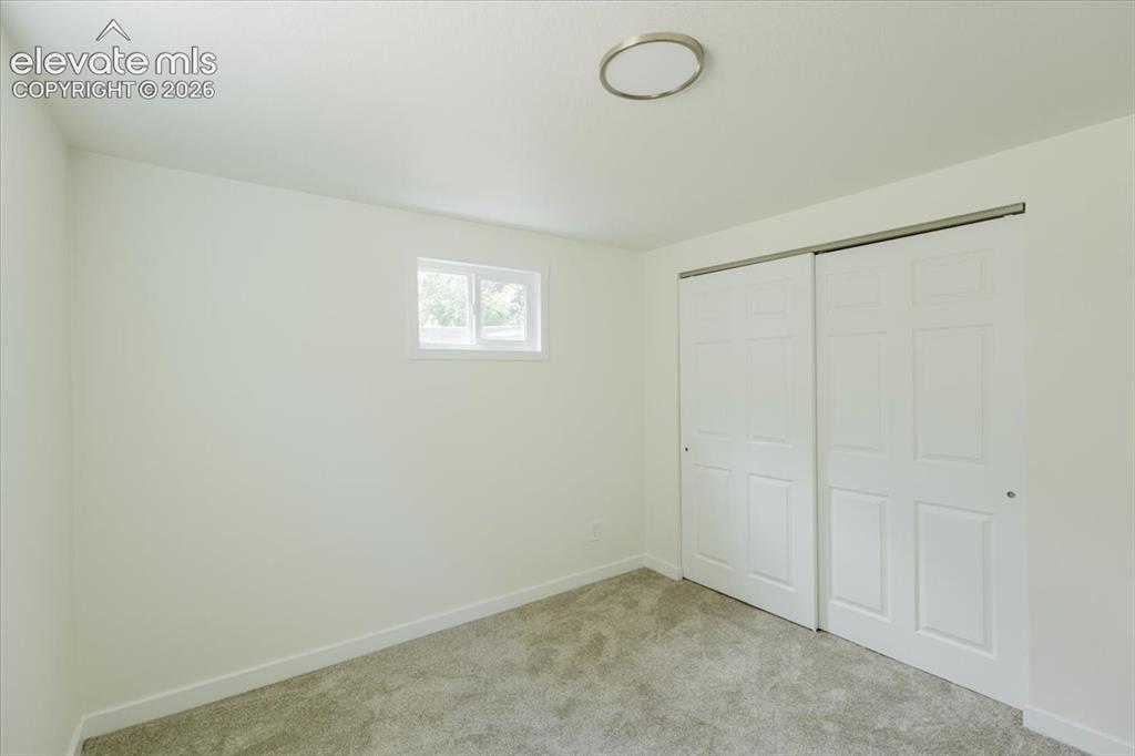Image 22 of 27: Room with neutral wall tones and light-toned carpeting