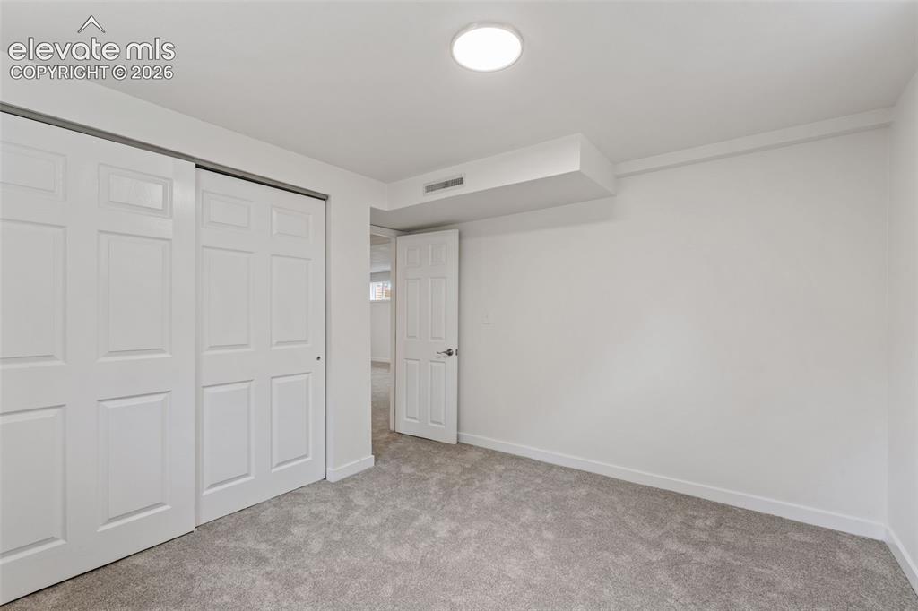 Image 30 of 35: Carpeted interior space featuring white walls and a white ceiling with a fl
