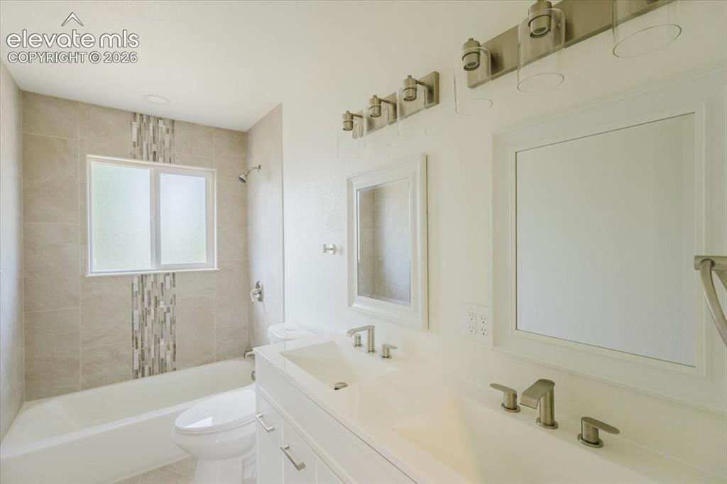 Image 8 of 27: Dual vanity with integrated sinks and brushed nickel fixtures