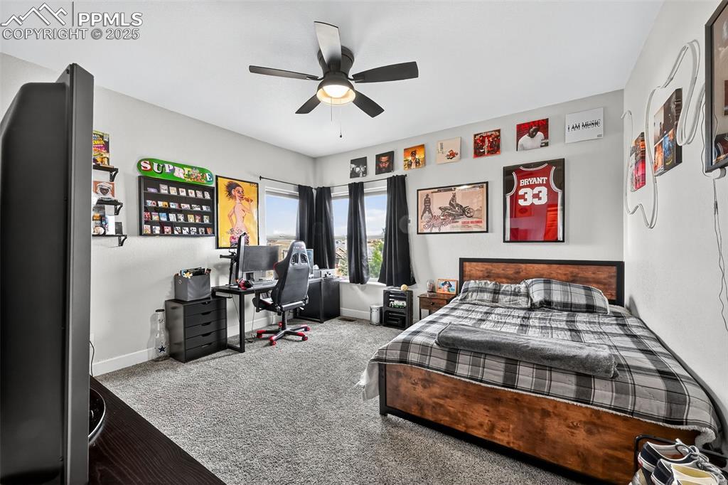 Image 17 of 39: Bedroom featuring carpet floors, a ceiling fan, and a desk