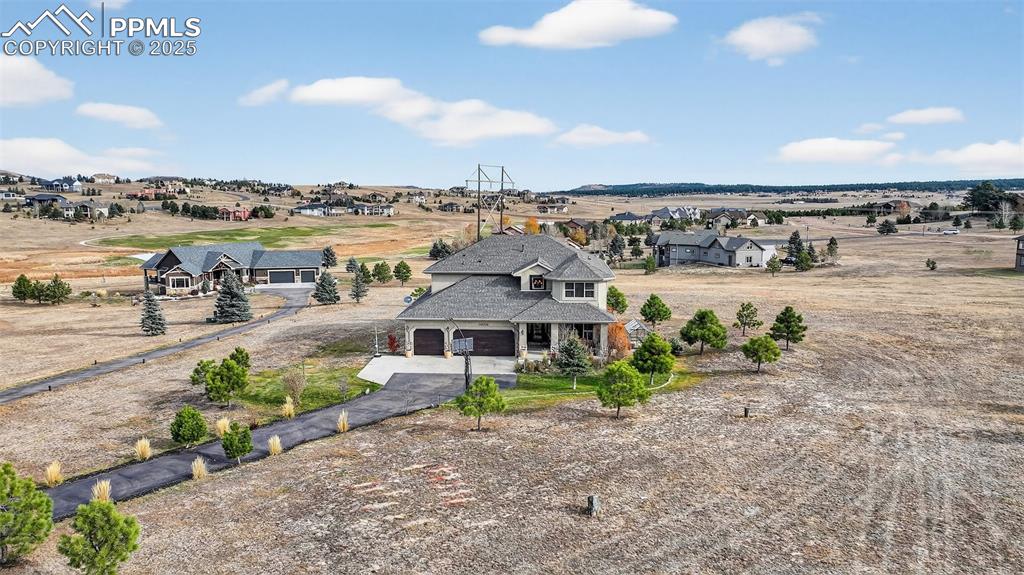 Image 2 of 39: Back of property featuring driveway and a residential view