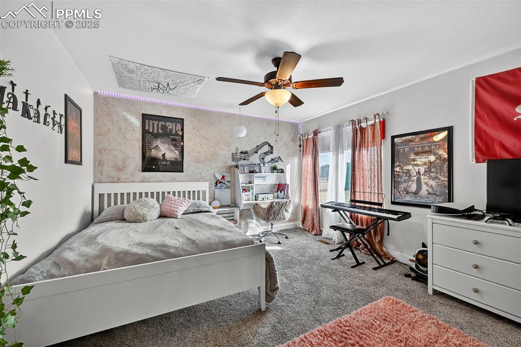Image 23 of 39: Carpeted bedroom featuring baseboards and ceiling fan