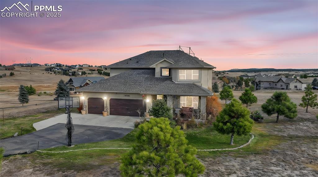 Image 3 of 39: Traditional-style house featuring concrete driveway, stucco siding, a garag