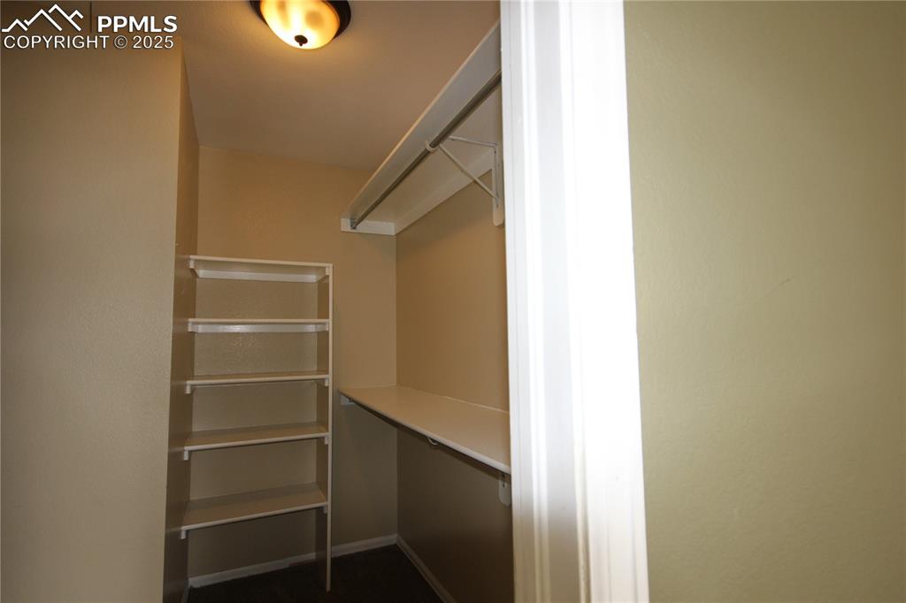 Image 18 of 32: Primary walk in closet