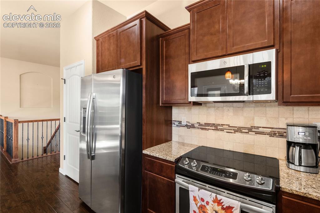 Image 13 of 33: Wood cabinetry and separate pantry closet