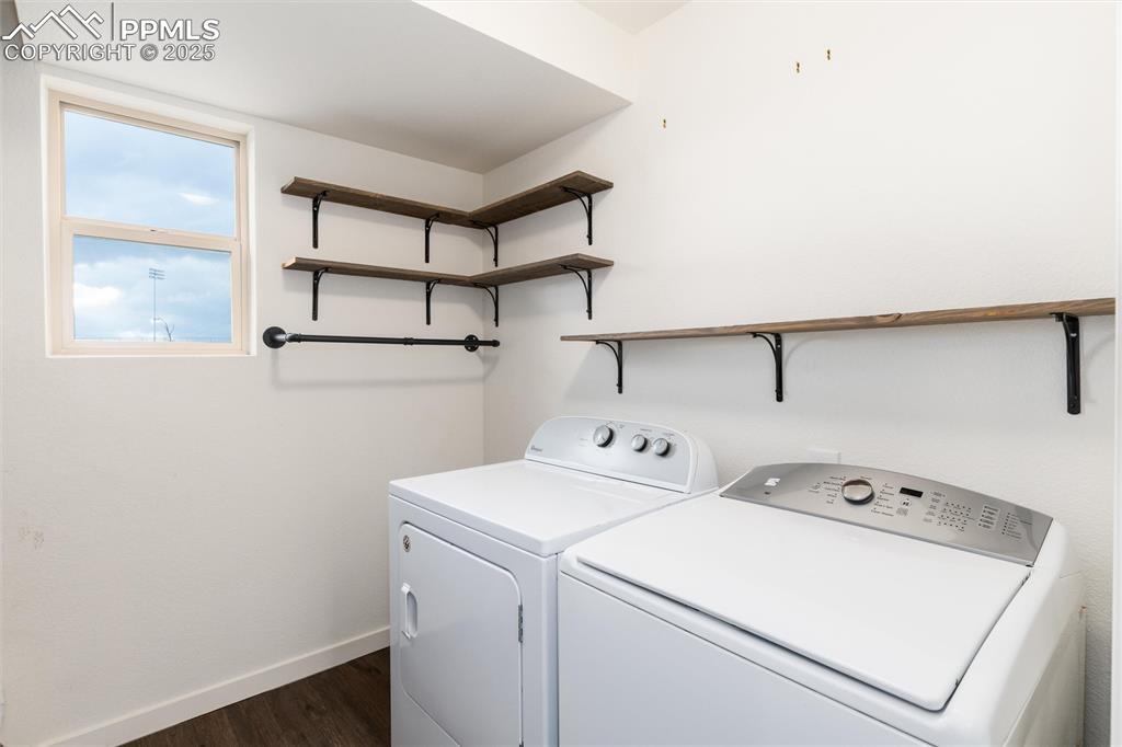 Image 24 of 33: Laundry room featuring baseboards, dark wood-style flooring, and washer and