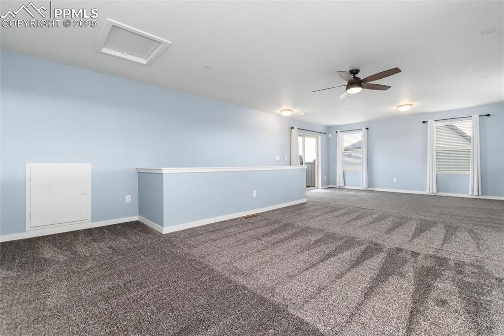 Image 27 of 33: Carpeted spare room featuring a ceiling fan and baseboards