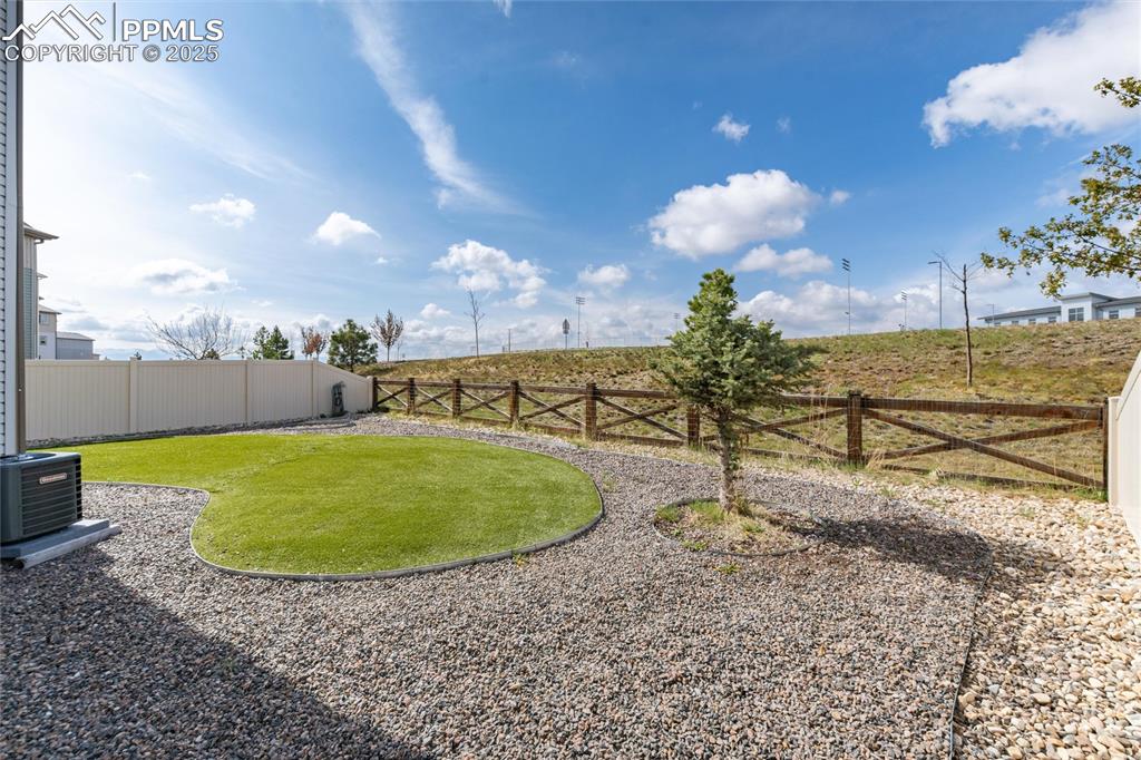 Image 31 of 33: View of yard featuring central AC unit