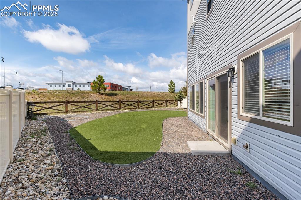Image 32 of 33: View of fenced backyard