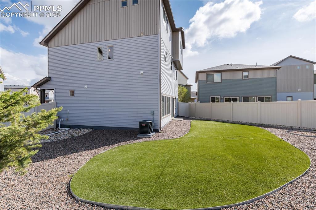 Image 33 of 33: Rear view of property with cooling unit