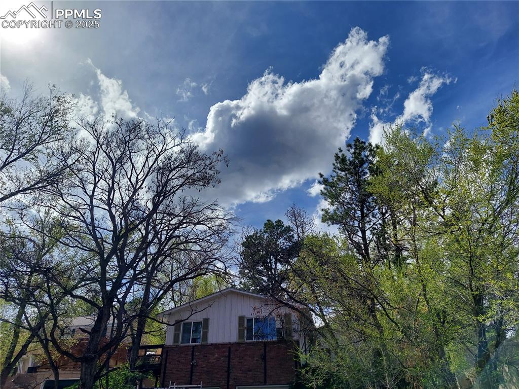 Caption: View of side of home featuring brick siding and board and batten siding