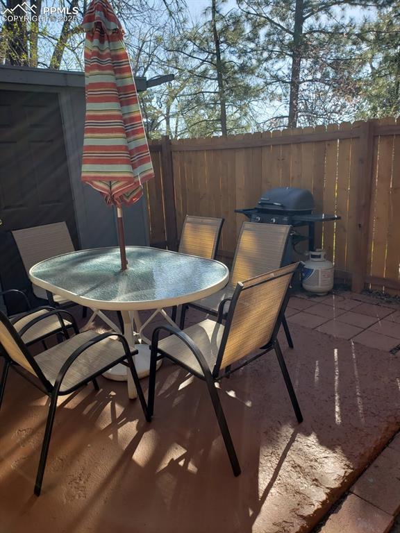Image 2 of 7: View of patio / terrace featuring outdoor dining space, fence, and area for