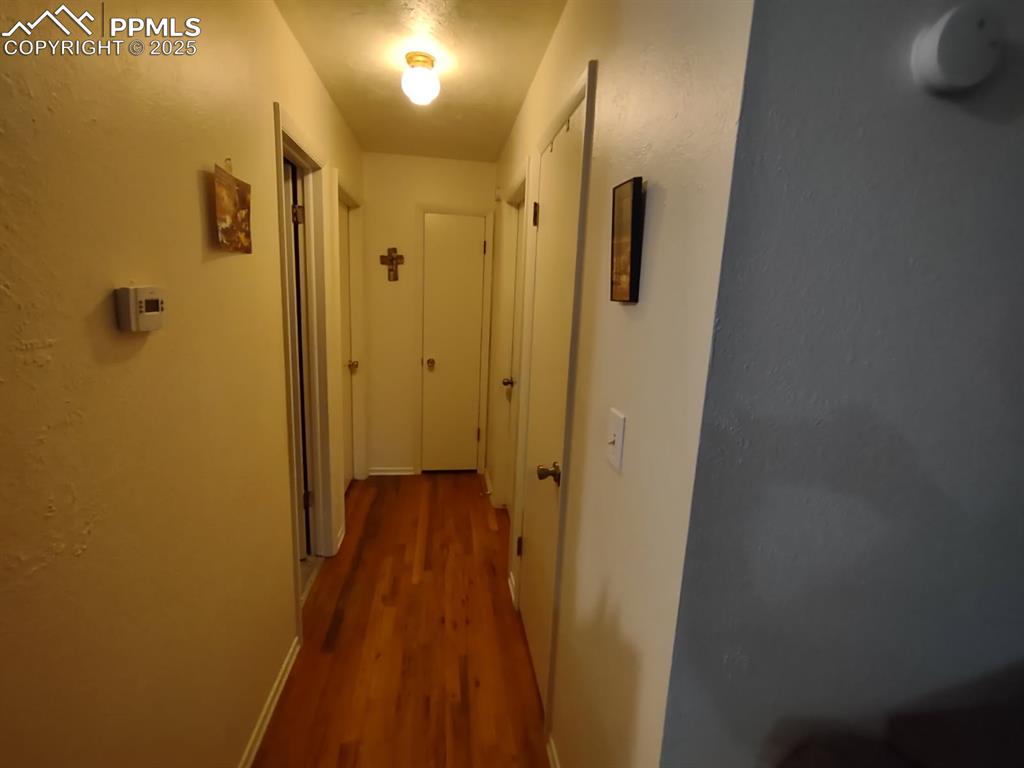 Image 3 of 7: Corridor with wood finished floors and baseboards