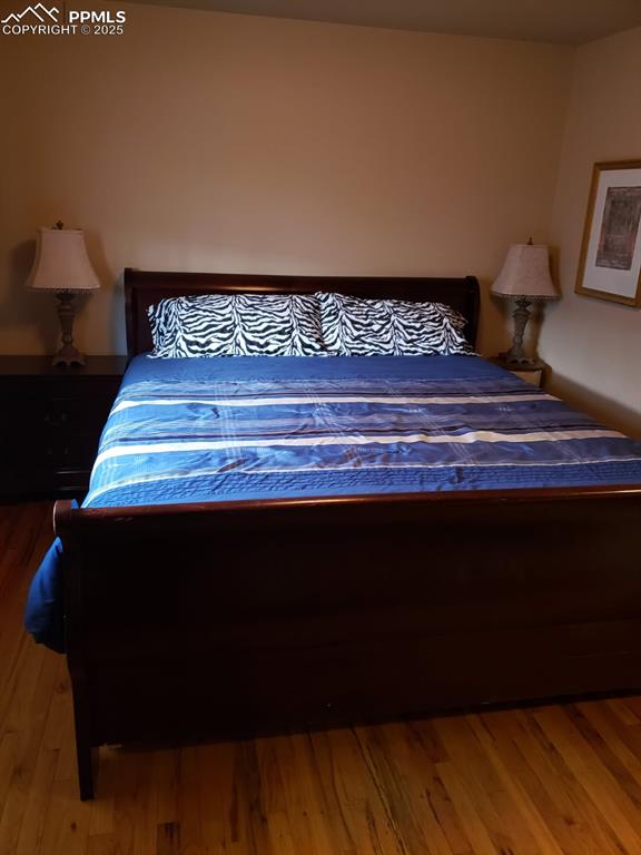 Image 6 of 7: Bedroom featuring wood finished floors