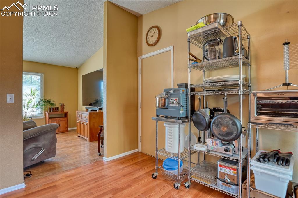 Image 12 of 38:  Breakfast area with light wood-style floors and lofted ceiling