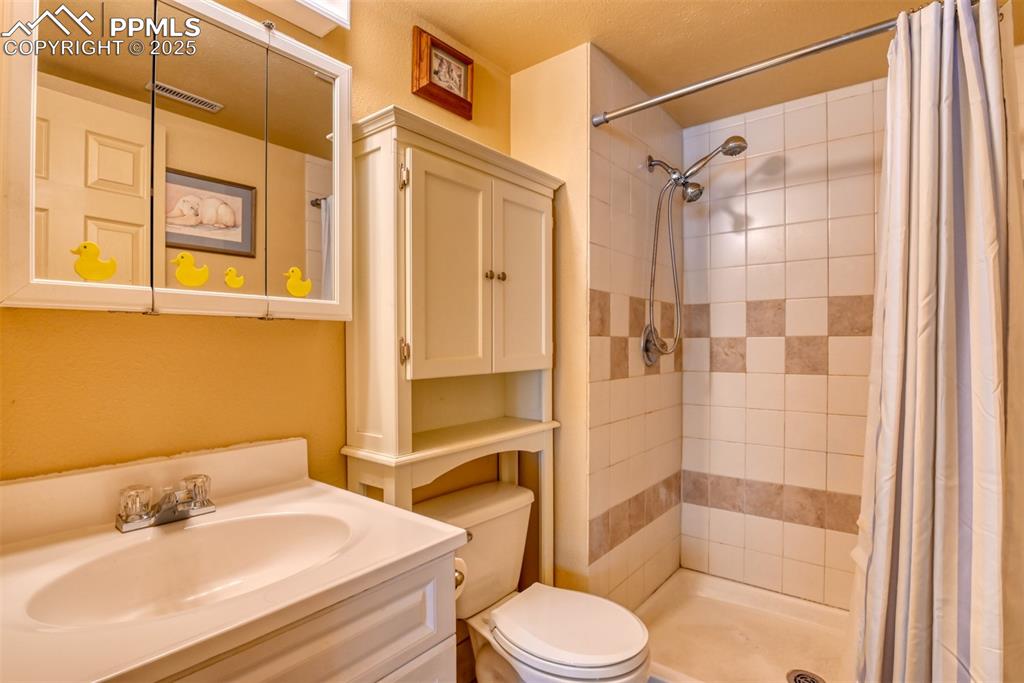 Image 16 of 38: Full bath featuring vanity and a shower stall