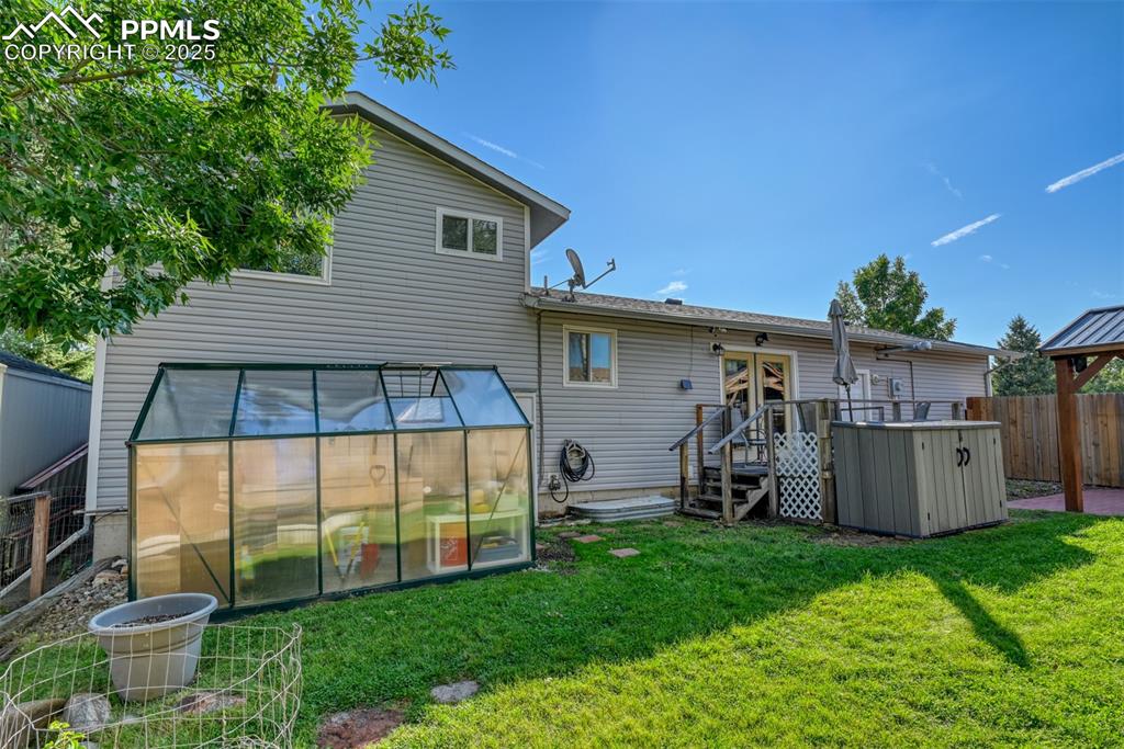 Image 33 of 38: Rear view of house featuring an exterior structure, a gazebo, and an outdoo