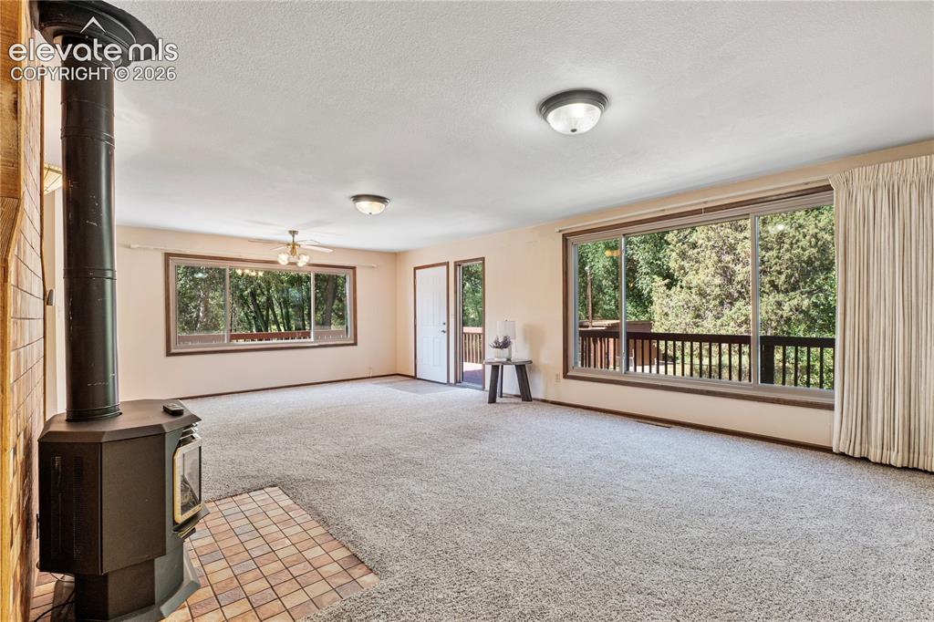 Image 18 of 49: Main Level Family/Dining Combo w/2 picture huge "picture" windows, walks ou