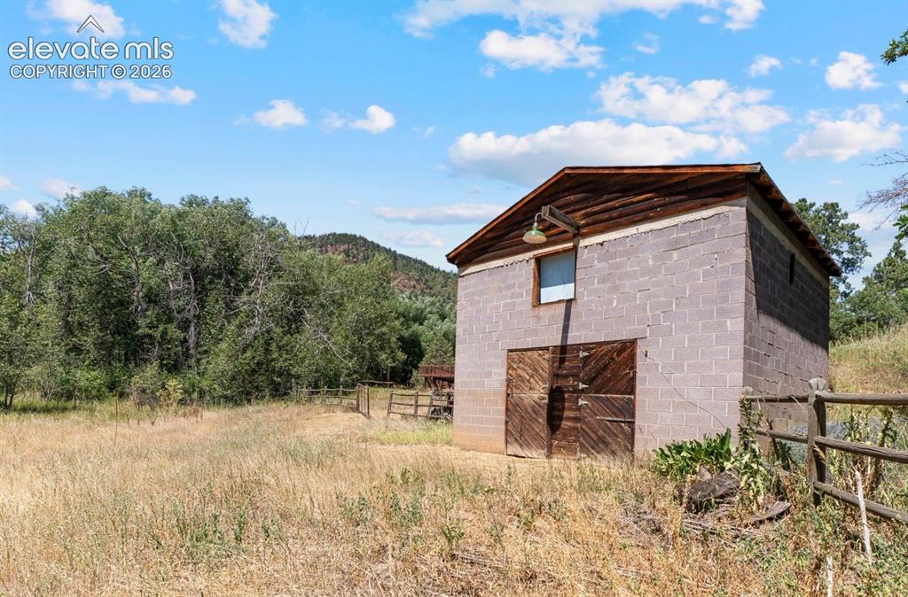 Image 37 of 49: The Barn: Hay loft, 4 stalls (2 doubles), metal roof and 220V electric!