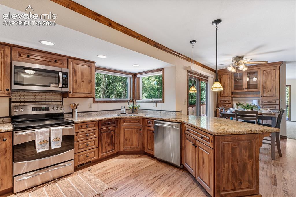 Image 8 of 49: Remodeled kitchen with local Brooks Brothers custom cabinetry and slab gran