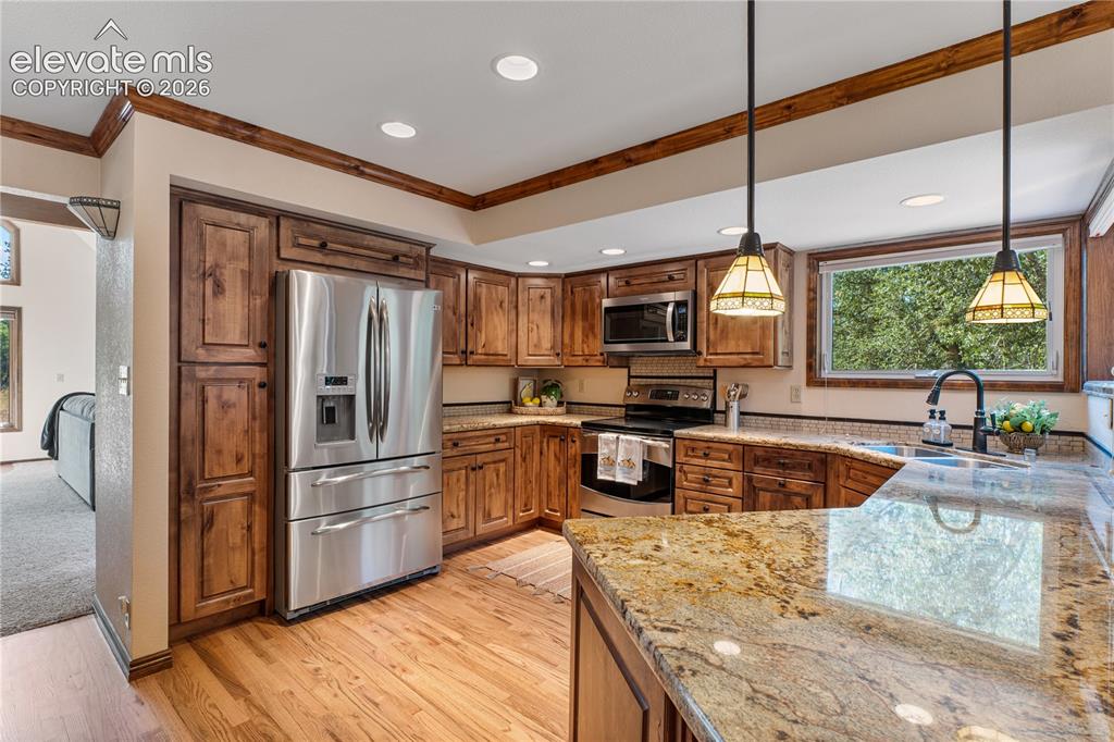 Image 9 of 49: Beautiful hardwood flooring in the kitchen & nook!