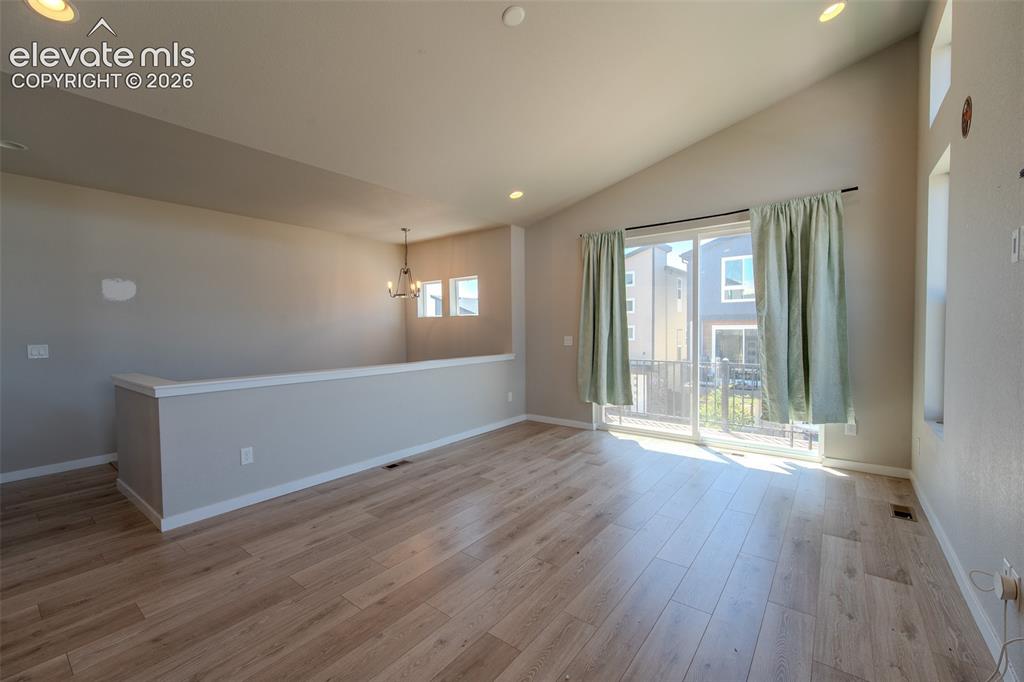 Image 13 of 46: Upper Level Living Room with sliding door to a composite balcony.