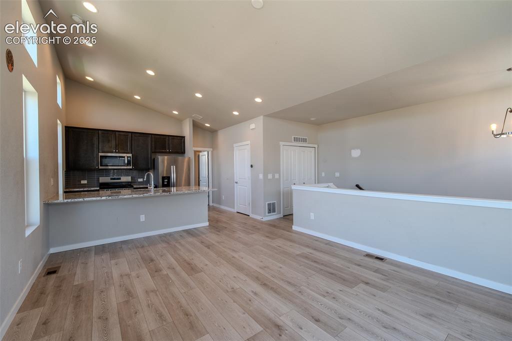 Image 16 of 46: View of the Kitchen from the Living Room/Dining Room.