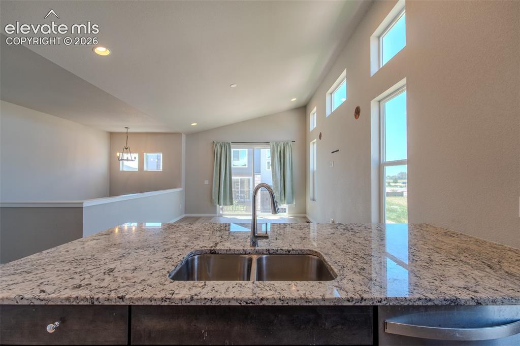 Image 21 of 46: Beautiful granite breakfast bar overlooking the Dining Area and Living Room