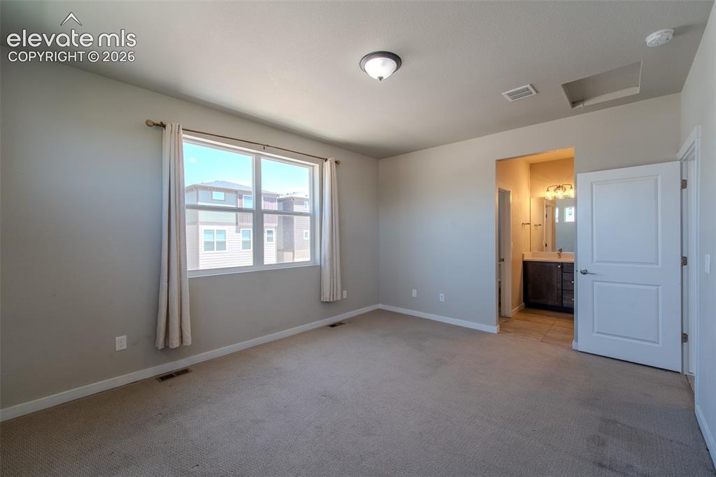 Image 25 of 46: The Upper Level Primary Bedroom is a private retreat with a walk in closet